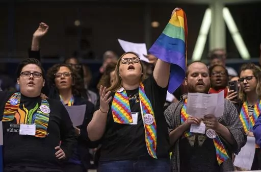 Shelby Ruch-Teegarden, center, of Garrett-Evangelical Theological Seminary, joins other protestors during the United Methodist Church's special session of the general conference in St. Louis, Tuesday, Feb. 26, 2019. United Methodist rules forbid same-sex marriage rites and the ordination of “self-avowed practicing homosexuals,” but progressive Methodist churches in the U.S. have increasingly been defying these rules. (AP Photo/Sid Hastings, File)