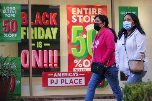 Black Friday shoppers wearing face masks shop at the Citadel Outlets in Commerce, Calif., Nov. 26, 2021. Black Friday sales are everywhere. But what actually makes a Black Friday deal worth pursuing? An item’s reduced price, availability and affordability are key elements. (AP Photo/Ringo H.W. Chiu, File)