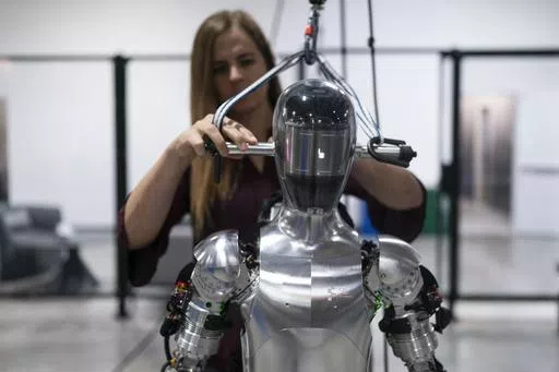 AI engineer Jenna Reher works on humanoid robot Figure 01 at Figure AI's test facility in Sunnyvale, Calif., Oct. 3, 2023. ChatGPT-maker OpenAI is looking to fuse its artificial intelligence systems into the bodies of humanoid robots as part of a new deal with robotics startup Figure. Sunnyvale, California-based Figure announced the partnership Thursday, Feb. 29, 2024, along with $675 million in venture capital funding from a group that includes Amazon founder Jeff Bezos as well as Microsoft, ch