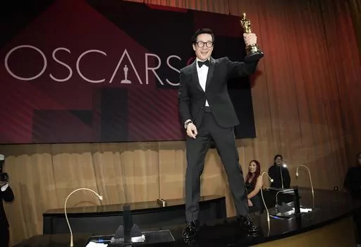 Ke Huy Quan poses with his award for best performance by an actor in a supporting role for "Everything Everywhere All at Once" at the Governors Ball after the Oscars on Sunday, March 12, 2023, at the Dolby Theatre in Los Angeles. (AP Photo/John Locher)