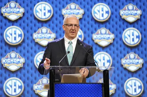 CORRECTS FIRST NAME TO GREG, NOT GEORGE AS ORIGINALLY SENT - Southeastern Conference commissioner Greg Sankey speaks during SEC NCAA college football media days Monday, July 15, 2024, in Dallas. (AP Photo/Jeffrey McWhorter)