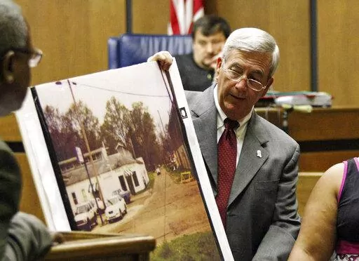 Prosecutor Doug Evans holds a photo during a trial for Curtis Flowers in court on June 14, 2010, in Greenwood, Miss. A federal appeals court on Thursday, June 16, 2022, affirmed the dismissal of a lawsuit that civil rights advocates filed against Evans. The 2019 lawsuit said Evans routinely rejected Black jurors in criminal cases because of their race, and it sought a declaration that Evans’ jury-selection practices violated prospective jurors’ constitutional rights. The appeals court ruled 