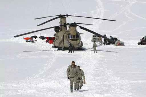  Capt. Corey Wheeler, front, commander of B Company, 1st Battalion, 52nd Aviation Regiment at Fort Wainwright, Alaska, walks away from a Chinook helicopter that landed on the glacier near Denali, April 24, 2016, on the Kahiltna Glacier in Alaska. The U.S. Army helped set up base camp on North America's tallest mountain. The U.S. Army is poised to revamp its forces in Alaska to better prepare for future cold-weather conflicts, and it is expected to replace the larger, heavily equipped Stryker Bri