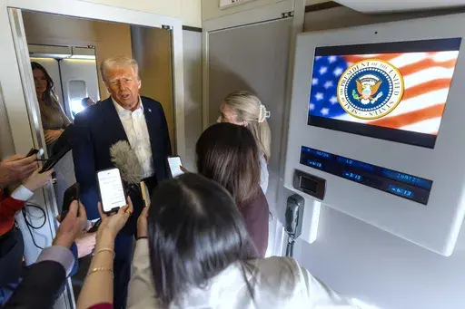 President Donald Trump speaks to reporters aboard Air Force One as he travels from Las Vegas to Miami on Saturday, Jan. 25, 2025. (AP Photo/Mark Schiefelbein)