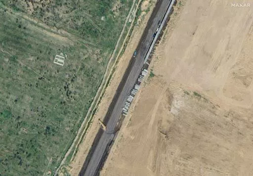 This satellite image provided by Maxar Technologies shows wall construction in Rafah, Egypt, Thursday, Feb. 15, 2024. (Maxar Technologies via AP)