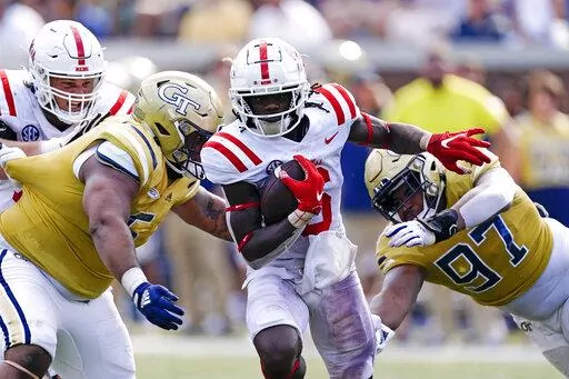Mississippi running back Zach Evans (6) runs through Georgia Tech defensive linemen T.K. Chimedza (5) and Akelo Stone (97) on his way to a touchdown in the first half of an NCAA college football game, Saturday, Sept. 17, 2022, in Atlanta. (AP Photo/John Bazemore)