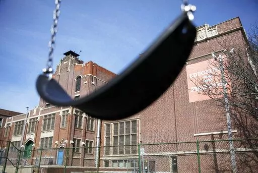 A swing sits empty on a playground outside  in Providence, R.I., March 7, 2020. Columbia University’s Center on Poverty and Social Policy estimates that the number of children in poverty grew by 3.7 million from December 2021 to January 2022, a 41% increase, just one month without the expanded child tax credit payments. (AP Photo/David Goldman, File)