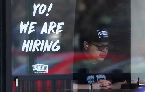 A hiring sign is displayed at a restaurant in Schaumburg, Ill., Friday, April 1, 2022. More Americans applied for unemployment benefits last week, and while layoffs remain low, it's the fifth straight week claims have topped the 230,000 mark. Applications for jobless aid for the week ending July 2 rose to 235,000, up 4,000 from the previous week, the Labor Department reported Thursday, July 7. (AP Photo/Nam Y. Huh, File)