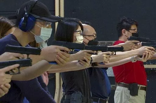 People shoot air soft guns at a private civilian training organization named Polar Light Training in New Taipei City, Taiwan on June 21, 2022. While an invasion doesn’t appear imminent, China's recent large-scale military exercises in response to a visit by U.S. House Speaker Nancy Pelosi to Taiwan have made the government in Taipei more aware than ever of the hard power behind Beijing’s rhetoric about bringing the self-ruled island under its control. Experts said that civilian defense and r