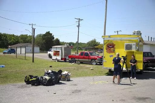 News crews film at the scene of a fatal shooting that happened at a Memorial Day event in Taft, Okla., on Sunday, May 29, 2022. (Ian Maule/Tulsa World via AP)