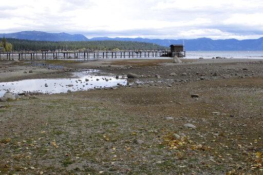 A pier and dock sits above Lake Tahoe's receding shoreline Wednesday, Oct. 20, 2021 at Tahoe City, Calif. There’s no relief in sight for the West’s record-shattering megadrought, which will likely only deepen this spring, the National Oceanic and Atmospheric Administration said in its seasonal outlook Thursday, March 17, 2022. But central and eastern states should be mostly spared from significant flooding. (AP Photo/Scott Sonner, File)