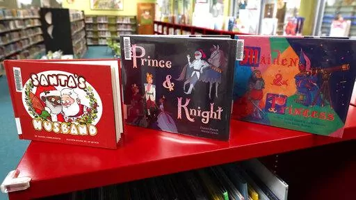 The executive director of the Madison County Library System, says Ridgeland, Miss., Mayor Gene McGee is withholding $110,000 from his city's library because LGBTQ genre books similar to these, photographed Thursday, Jan. 27, 2022, in Ridgeland, are on the shelves of the city's library. The director of the county said the mayor had received citizen complaints about a handful of books that depicted members of the LGBTQ community. (AP Photo/Rogelio V. Solis)