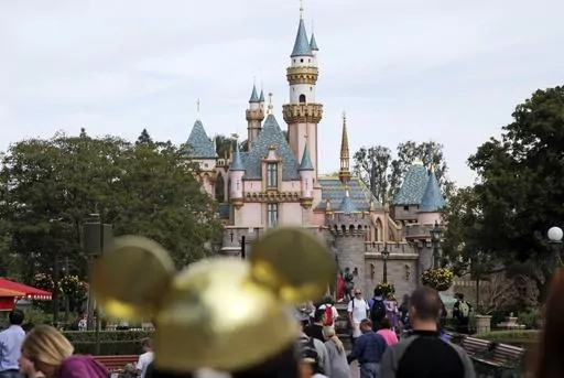 In this Jan. 22, 2015 file photo, visitors walk toward the Sleeping Beauty's Castle in the background at Disneyland Resprt in Anaheim, Calif. Last year, 2022, marked a return to normal for the theme park industry around the world with operators reporting revenues, and sometimes attendance, at par or above pre-pandemic levels, according to a new report. (AP Photo/Jae C. Hong, File)
