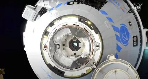 This image from NASA TV shows the Boeing Starliner preparing to dock at the International Space Station, Friday, May 20, 2022. Boeing's astronaut capsule has arrived at the International Space Station in a critical repeat test flight. Only a test dummy was aboard the capsule for Friday's docking, a huge achievement for Boeing after years of false starts. (NASA via AP)