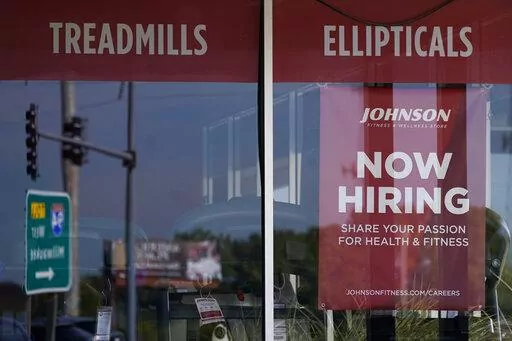 Hiring sign is displayed in Northbrook, Ill., Sept. 21, 2022. The number of Americans applying for unemployment benefits fell last week and remains historically low even as the U.S. economy slows in the midst of decades-high inflation. Jobless claims for the week ending Oct. 15 declined by 12,000 to 214,000 from 226,000 last week, the Labor Department reported Thursday, Oct. 20, 2022. (AP Photo/Nam Y. Huh)