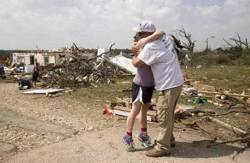Michelle Light hugs her uncle Paul Bales on Wednesday April 13, 2022, a day after a tornado destroyed her home on FM 2843 and Cedar Valley Road near Salado, Texas. Nearly two dozen people were injured when tornadoes swept through central Texas as part of a storm system that’s expected to spawn more twisters and damaging winds Wednesday (Jay Janner/Austin American-Statesman via AP)