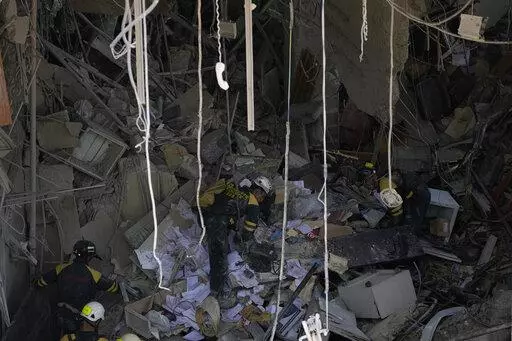 Rescuers search for survivors at the site of Friday's deadly explosion that destroyed the five-star Hotel Saratoga, in Havana, Cuba, Saturday, May 7, 2022. (AP Photo/Ramon Espinosa)