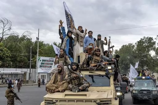 Taliban fighters celebrate one year since they seized the Afghan capital, Kabul, in front of the U.S. Embassy in Kabul, Afghanistan, Monday, Aug. 15, 2022. (AP Photo/Ebrahim Noroozi, File)