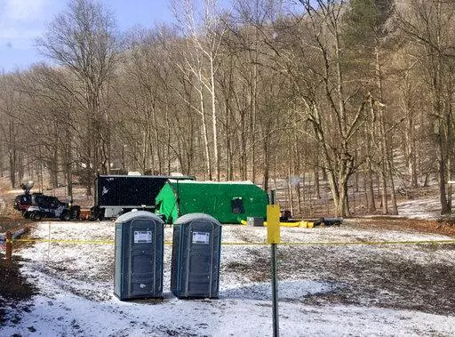 FBI agents and representatives of the Pennsylvania Department of Conservation and Natural Resources set up a base in March, 2018, in Benezette Township, Elk County, Pa. A scientific report commissioned by the FBI shortly before agents went digging for buried treasure suggested that a huge quantity of gold was below the surface, according to newly released government documents. (Katie Weidenboerner/The Courier-Express via AP, File)