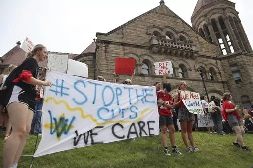 West Virginia University students lead a protest against cuts to programs in world languages, creative writing and more amid a $45 million budget deficit, Aug. 21, 2023, outside Stewart Hall in Morgantown, W.Va. (AP Photo/Leah Willingham, File)