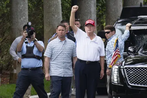 President Donald Trump gestures to supporters gathered for a Presidents Day rally as he leaves the Trump International Golf Club, Monday, Feb. 17, 2025, in West Palm Beach, Fla. (AP Photo/Ben Curtis)