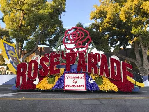 FILE - In this Jan. 1, 2020, file photo, a 2020 Rose Parade float is seen at the start of the route at the 131st Rose Parade in Pasadena, Calif. The Rose Parade and Rose Bowl college football game between Ohio State and Utah were set to go forward on New Year's Day despite surging cases of COVID-19, which forced the cancelation of the 2021 parade. (AP Photo/Michael Owen Baker, File)