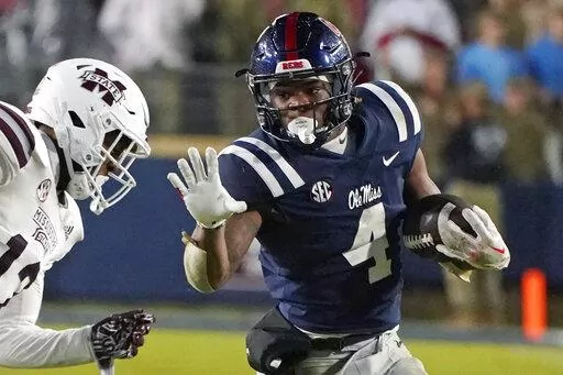 Mississippi running back Quinshon Judkins (4) looks to fend off Mississippi State safety Shawn Preston Jr. (12) during the second half of an NCAA college football game in Oxford, Miss., Thursday, Nov. 24, 2022. Ole Miss looks to end a disappointing season on a positive note Wednesday night, Dec. 28, 2022 when the Rebels meet Texas Tech in the Texas Bowl. (AP Photo/Rogelio V. Solis, File)