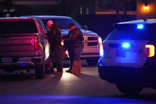 Las Vegas police work near the home of former actor Nathan Lee Chasing His Horse, who goes by Nathan Chasing Horse, Tuesday, Jan. 31, 2023, in North Las Vegas, Nev. Authorities raided the home of the former actor Tuesday in connection with a sexual assault investigation. (AP Photo/John Locher)