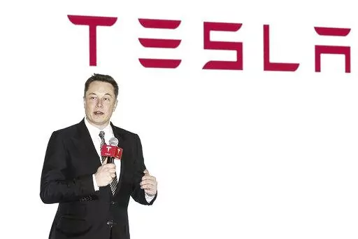 Tesla CEO Elon Musk holds a press conference to introduce the auto-driving system upgrade for Chinese Tesla owners in Beijing, China on Oct. 23, 2015. Activists on Monday, Jan 3. 2022 are appealing to Elon Musk and Tesla Inc. to close a new showroom in China's northwestern region of Xinjiang, where officials are accused of abuses against mostly Muslim ethnic minorities. (Chinatopix via AP)