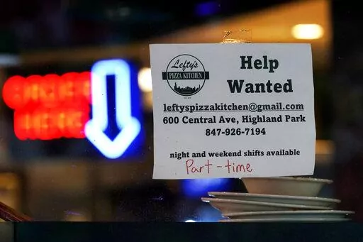 Hiring sign is displayed at a restaurant in Highland Park, Ill., Thursday, July 14, 2022.   The number of Americans applying for unemployment benefits last week rose to its highest level in more than eight months, a sign the labor market may be showing some weakness. Applications for jobless aid for the week ending July 16 rose by 7,000 to 251,000, up from the previous week’s 244,000, the Labor Department reported Thursday, July 21.  (AP Photo/Nam Y. Huh)