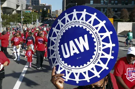 United Auto Workers members walk in the Labor Day parade in Detroit, Sept. 2, 2019. (AP Photo/Paul Sancya, File)