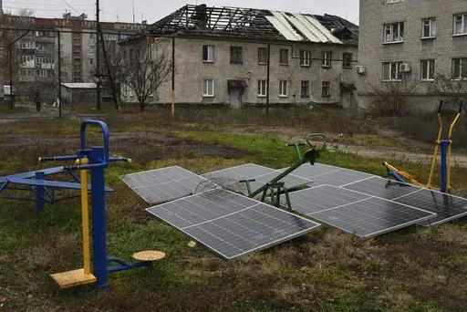 Solar panels sit in the yard of an apartment building in Lyman, Donetsk region, Ukraine, Nov. 20, 2022. (AP Photo/Andriy Andriyenko, File)