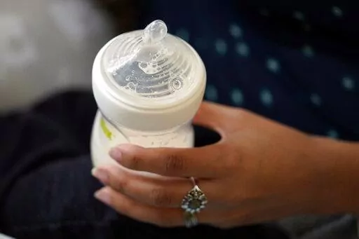 A mother holds a bottle of baby formula as she feeds her infant son, Friday, May 13, 2022, in San Antonio. Federal health officials are warning parents of newborns, Thursday, March 2, 2023, to sterilize equipment used for both bottle- and breast-feeding after a baby died last year from a rare infection tied to a contaminated breast pump. (AP Photo/Eric Gay)