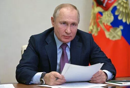 Russian President Vladimir Putin attends a cabinet meeting via video conference at the Novo-Ogaryovo residence outside Moscow, Russia, Friday, Dec. 24, 2021. (Alexei Nikolsky, Sputnik, Kremlin Pool Photo via AP)
