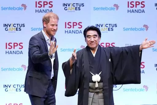 Britain's Prince Harry, escorted by Haruhisa Handa, CEO of the International Sports Promotion Society (ISPS), attends an event organized by the ISPS Wednesday, Aug. 9, 2023, in Tokyo. The program included topics such as the power of sport, community and philanthropy. Harry will travel to Singapore to play in the Sentebale ISPS Handa Polo Cup on Aug. 12. (AP Photo/Eugene Hoshiko)