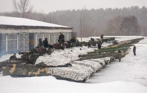 Ukrainian soldiers examine their tanks at a military unit close to Kharkiv, Ukraine, Monday, Jan. 31, 2022. Russia's foreign minister claims that NATO wants to pull Ukraine into the alliance, amid escalating tensions over NATO expansion and fears that Russia is preparing to invade Ukraine. (AP Photo/Andrew Marienko)