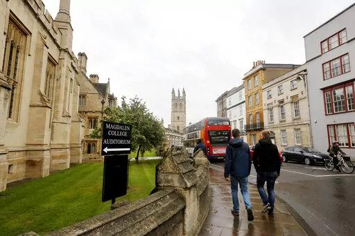People walk around Oxford University's campus in Oxford, England on Sept. 3, 2017. A new group of Rhodes Scholars from the U.S. has been selected for the prestigious academic program in a selection process that was conducted online for the third consecutive year,  the Office of the American Secretary of the Rhodes Trust said in a statement early Sunday, Nov. 13, 2022. (AP Photo/Caroline Spiezio, File)