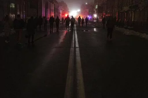 People walk through the city center which lost electrical power after yesterday's Russian rocket attack in Kyiv, Ukraine, Nov. 24, 2022. The hard realities of Ukraine’s capital are that a once comfortably livable city of 3 million people is now becoming a tough place to live. But Kyiv has hope, resilience and defiance in abundance. And perhaps more so now than at any time since Russia invaded Ukraine nine months ago. (AP Photo/Evgeniy Maloletka, File)