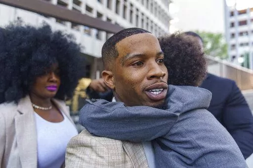Rapper Tory Lanez, 30, walks out of the courthouse while holding his 5-year-old son Kai'Lon, Tuesday, Dec. 13, 2022, in Los Angeles. Megan Thee Stallion took the stand Tuesday and told jurors that Lanez fired five shots at her feet, yelled at her to dance and wounded her as she tried to walk away from him in the Hollywood Hills more than two years ago. The Canadian rapper has pleaded not guilty to discharging a firearm with gross negligence, assault with a semiautomatic firearm and carrying a lo