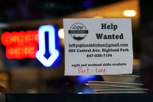 Hiring sign is displayed at a restaurant in Highland Park, Ill., Thursday, July 14, 2022. Fewer Americans filed for unemployment benefits last week as the labor market continues to shine despite weakening elements of the U.S. economy. Applications for jobless aid for the week ending Aug. 27, fell by 5,000 to 232,000, the Labor Department reported Thursday, Sept. 1.  (AP Photo/Nam Y. Huh)