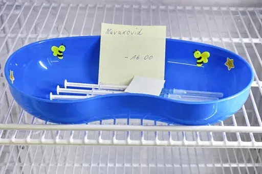A kidney dish with syringes containing the Novavax COVID-19 vaccine sits in a refrigerator ready for use at a vaccination center in Prisdorf, Germany, Saturday, Feb. 26, 2022. On Tuesday, July 19, 2022, a U.S. Centers for Disease Control and Prevention advisory panel recommended the shots and final action will come from the agency's director. (Georg Wendt/dpa via AP, File)