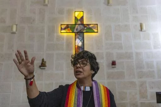 Rev. Elaine Saralegui, wearing a rainbow-colored clergy stole and her clerical collar, leads a service at the Metropolitan Community Church, an LGBTQ+ inclusive house of worship, in Matanzas, Cuba, Friday, Feb. 2, 2024. In recent years, the communist-run island barred anti-gay discrimination, and a 2022 government-backed “family law” — approved by popular vote — allowed same-sex couples the right to marry and adopt. (AP Photo/Ramon Espinosa) (AP Photo/Ramon Espinosa)