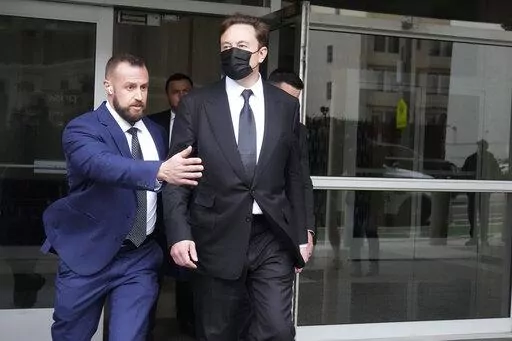 Elon Musk, center, leaves a federal courthouse in San Francisco, Friday, Feb. 3, 2023. A high-profile trial focused on a 2018 tweet about the financing for a Tesla buyout that never happened drew a surprise spectator for Friday's final arguments — Elon Musk, the billionaire who is being accused of misleading investors with his usage of the Twitter service he now owns. (AP Photo/Jeff Chiu)