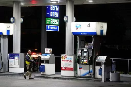An attendant walks past a pump at a station selling gas at over $6 a gallon, Monday, March 7, 2022, in Los Angeles. Governors and state lawmakers across the U.S. are scrambling to provide relief from soaring prices at the gas pump. They are discussing ways to lower or suspended gas taxes, but taking that step has not proved easy, since much of that money goes toward repair of roads and bridges. (AP Photo/Marcio Jose Sanchez, File)