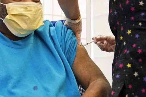 A 62-year-old nursing home resident receives a COVID-19 booster shot in New York on Monday, Sept. 27, 2021. A study released on Wednesday, Jan. 19, 2022 that compares coronavirus protection from prior infection and vaccination in New York and California concludes getting the shots is still the safest way to prevent COVID-19. (AP Photo/Seth Wenig, File)