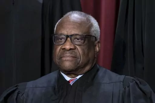Associate Justice Clarence Thomas joins other members of the Supreme Court as they pose for a new group portrait, at the Supreme Court building in Washington, Oct. 7, 2022. Thomas said Friday, April 7, that he was not required to disclose the many trips he and his wife took that were paid for by Republican megadonor Harlan Crow. The nonprofit investigative journalism organization ProPublica reported Thursday that Thomas, who has been a justice for more than 31 years, has for more than two decade