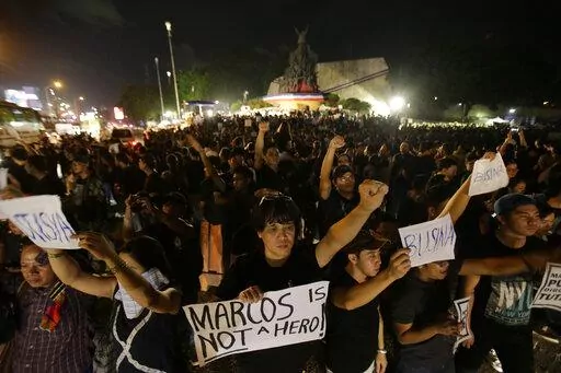  Demonstrators hold slogans as they gather at the People's Power Monument in Quezon city, north of Manila Philippines Friday, Nov. 18, 2016, to protest against the burial of the late dictator Ferdinand Marcos. Filipino   Filipino voters overwhelmingly elected Ferdinand "Bongbong" Marcos Jr., as president during the May 2022 elections, completing a stunning return to power for the family of the late President Ferdinand Marcos, Sr., who ruled the country for more than two decades until being ouste