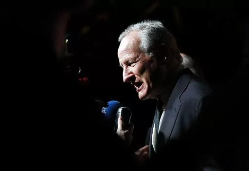 Director Michael Mann answers questions as he arrives for the opening ceremony of the ninth Lumiere Festival, in Lyon, central France, Oct. 14, 2017. Mann has co-written a novel that revisits the characters of his 1995 film "Heat" in both prequel and sequel fashion, filling in the backstory and what happened to characters played by Al Pacino, Robert De Niro and Val Kilmer. (AP Photo/Laurent Cipriani, File)