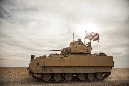 American soldiers drive a Bradley fighting vehicle during a joint exercise with Syrian Democratic Forces at the countryside of Deir Ezzor in northeastern Syria, Dec. 8, 2021. The U.S. and Germany are sending Ukraine an array of armored vehicles, including 50 tank-killing Bradleys, to expand its ability to move troops to the front lines and beef up its forces against Russia as the war nears its first anniversary. (AP Photo/Baderkhan Ahmad, File)