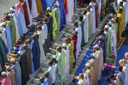 FILE — Worshipers in New York's East Harlem neighborhood take part in the traditional annual prayer commemorating the end of Ramadan, in front of the Masjid Aqsa-Salam mosque, on July 17, 2015. New York Mayor Eric Adams announced new guidelines Tuesday, Aug. 29, 2023, allowing mosques to broadcast the Muslim call to prayer on Fridays and at sundown during the holy month of Ramadan. (AP Photo/Bryan R. Smith, File)